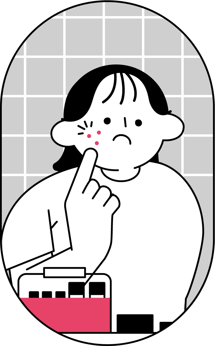 鏡でニキビに気づく女性